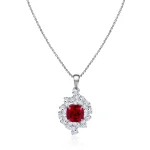 Cushion Cut Lab Ruby Pendant Featuring A Cluster Of Pear Cut Moissanite