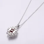 Cushion Cut Lab Ruby Pendant Featuring A Cluster Of Pear Cut Moissanite