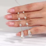 Linear Pear and Round Moissanite Drop Earrings with Bezel Accents