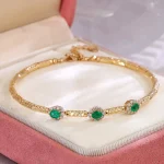 ​Emerald Halo Link Bracelet | Oval-Cut Emerald & Lab Diamond Halo Bracelet in 18K Yellow Gold​