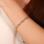 ​Emerald Halo Link Bracelet | Oval-Cut Emerald & Lab Diamond Halo Bracelet in 18K Yellow Gold​