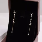 Long Linear Round Cut Moissanite Drop Earrings with Star Motifs - Image 2