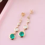 Round Emerald and Moissanite Graduated Swirl Drop Earrings
