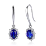 Oval Cut Lab Sapphire Earrings with Round Cut Moissanite Accent Halo Setting - Image 2